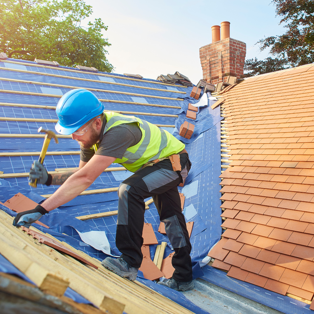 Guy in harness working on roof.png